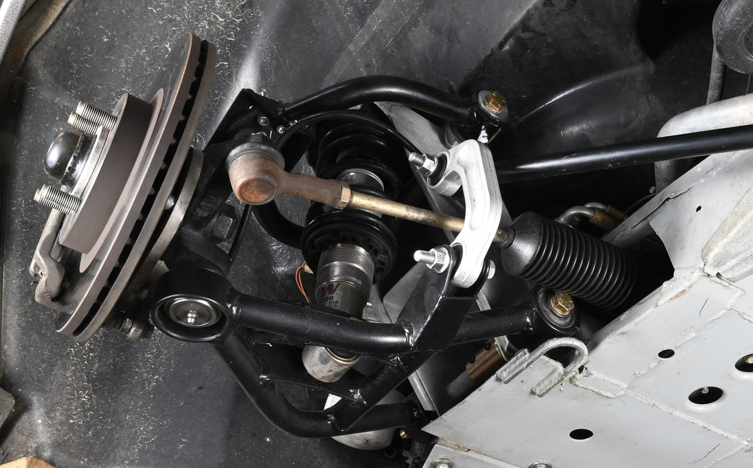 DeLorean tubular lower control arm assembly showcasing LCA upgrade for improved performance.